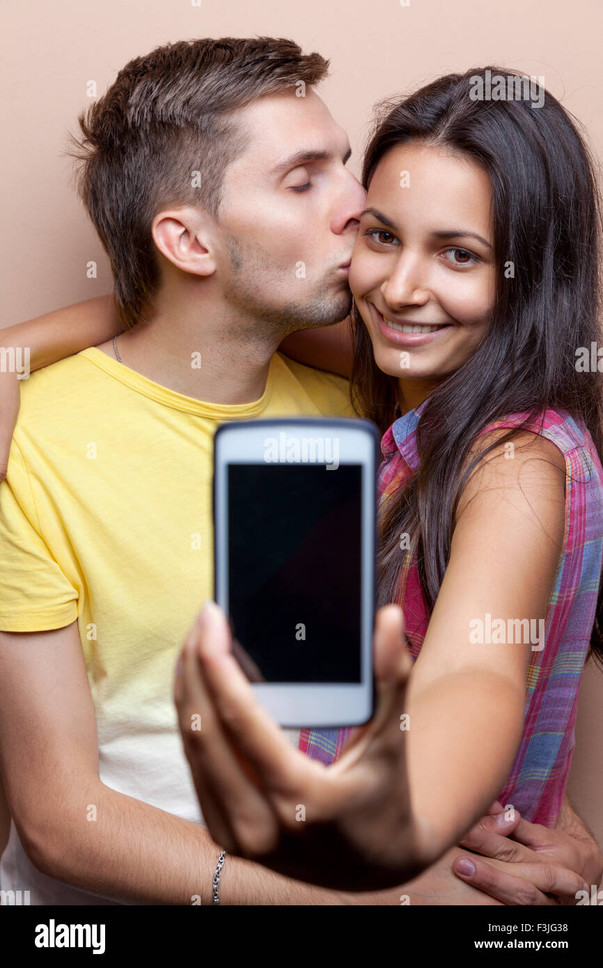 Young happy couple taking a selfie with mobile phone Stock Photo - Alamy