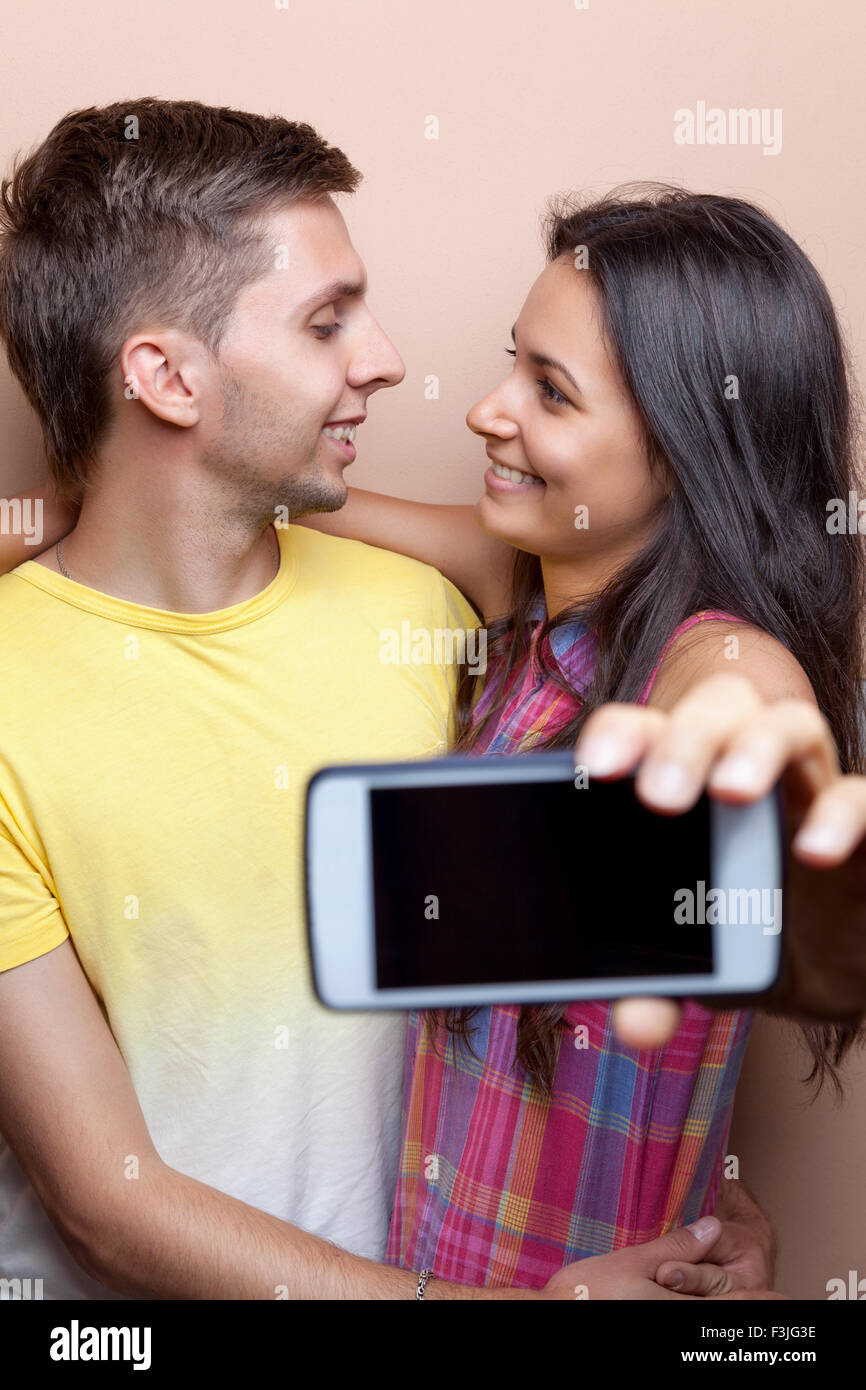 Young happy couple taking a selfie with mobile phone Stock Photo - Alamy
