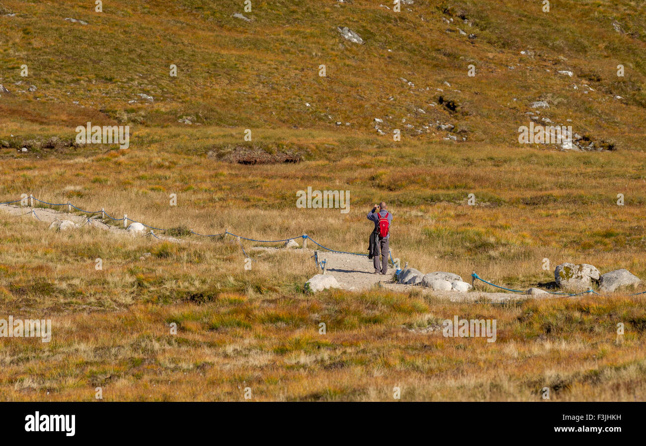 Walker making his way along the paths at the summit of Aonach Mor, Ben Nevis, Scotland. Stock Photo
