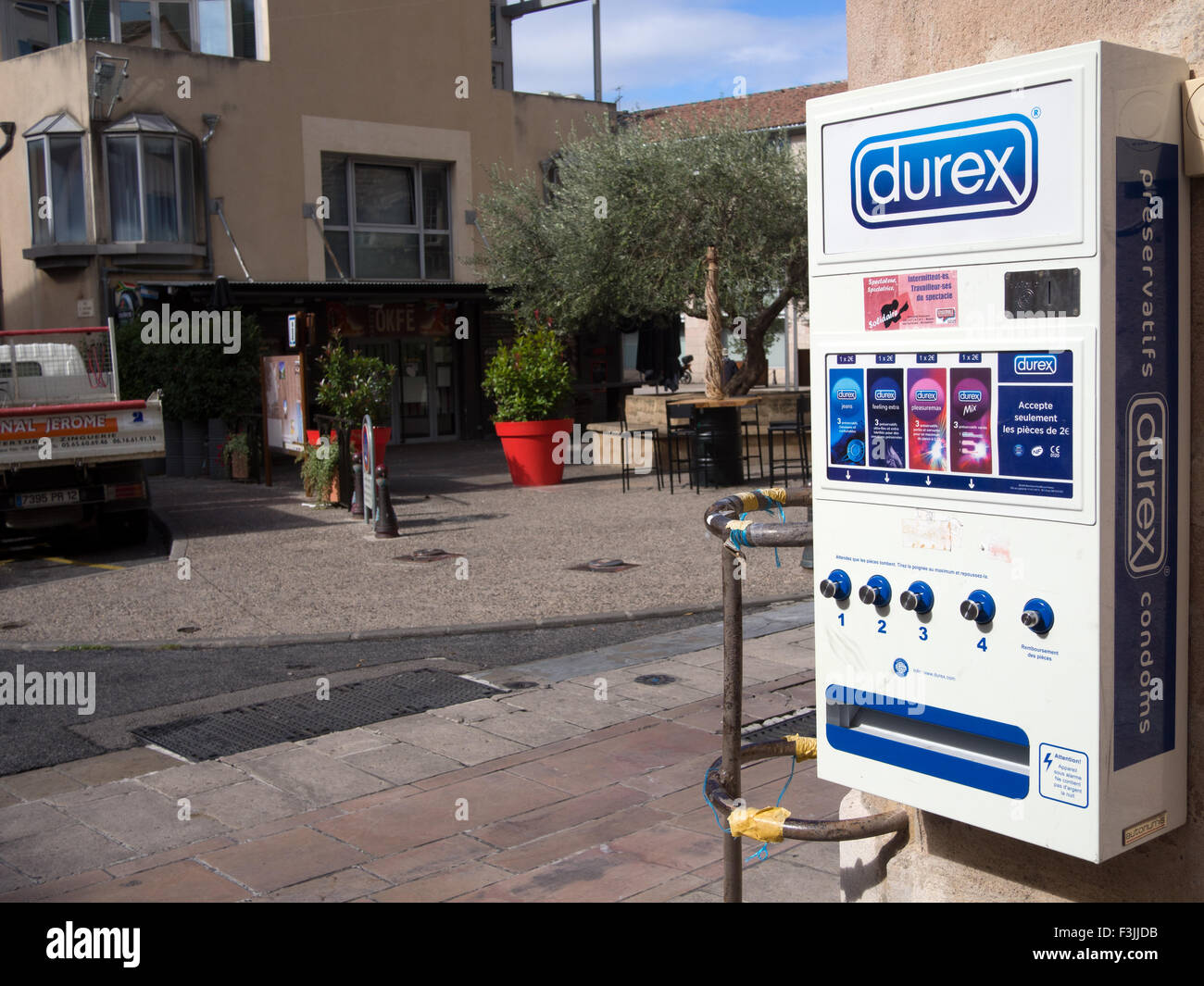 A Durex condom (preventatifs) machine on the outside of a pharmacy in Millau, France. Stock Photo