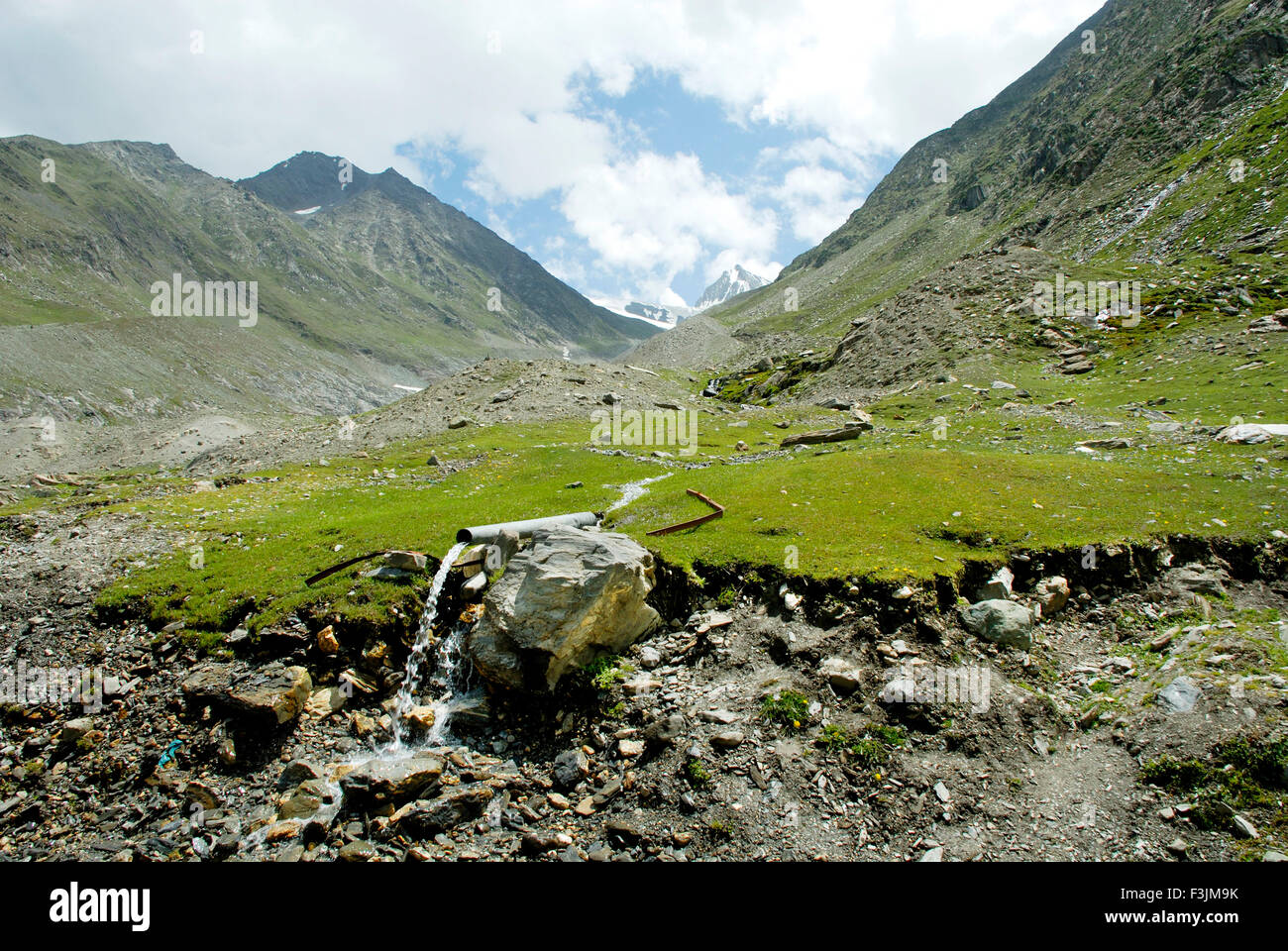 Collecting drinking water from mountain resource at ; Ladakh ; Jammu & Kashmir ; India Stock Photo