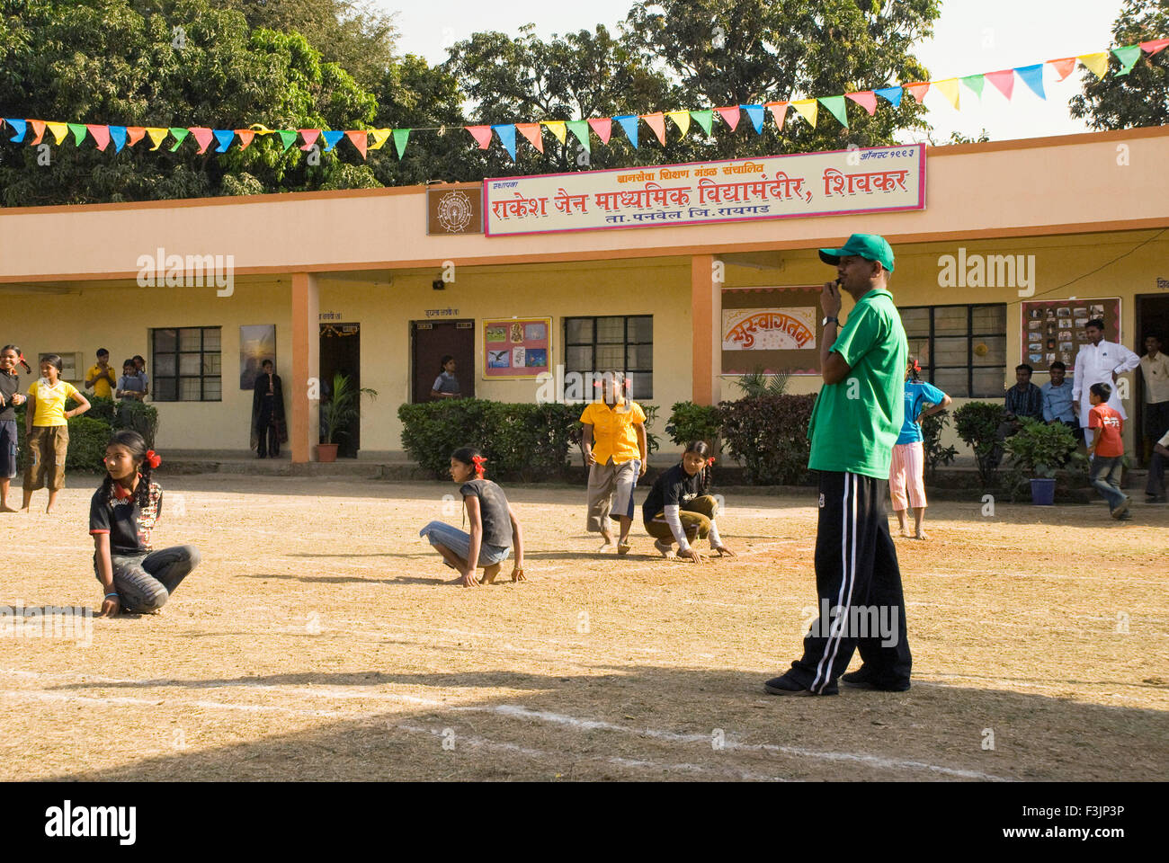 School children playing game Kho Kho tag sport at Shivkar Village Panvel taluka Maharashtra India Stock Photo