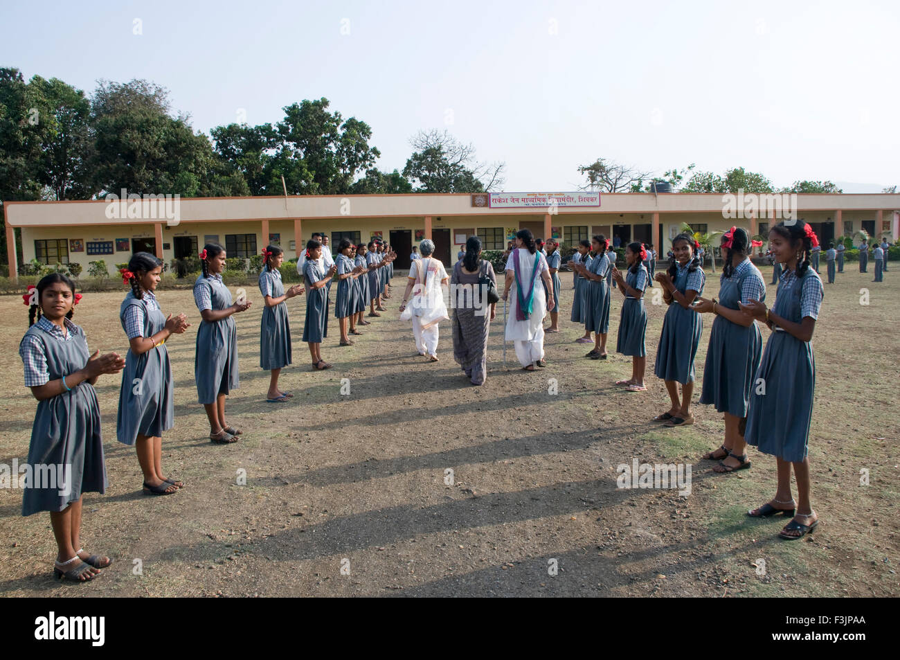 School girls welcoming guests at Shivkar village Panvel taluka Maharashtra India Stock Photo