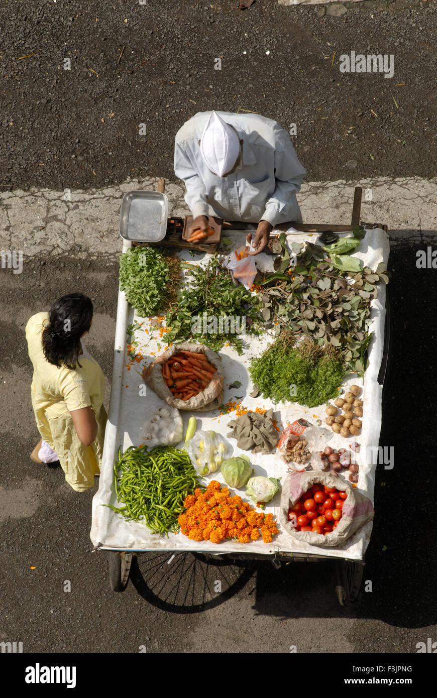 Vegetables vendor on handcart, woman buying, Vithalwadi, Poona,  Pune, Maharashtra, India, Asia Stock Photo