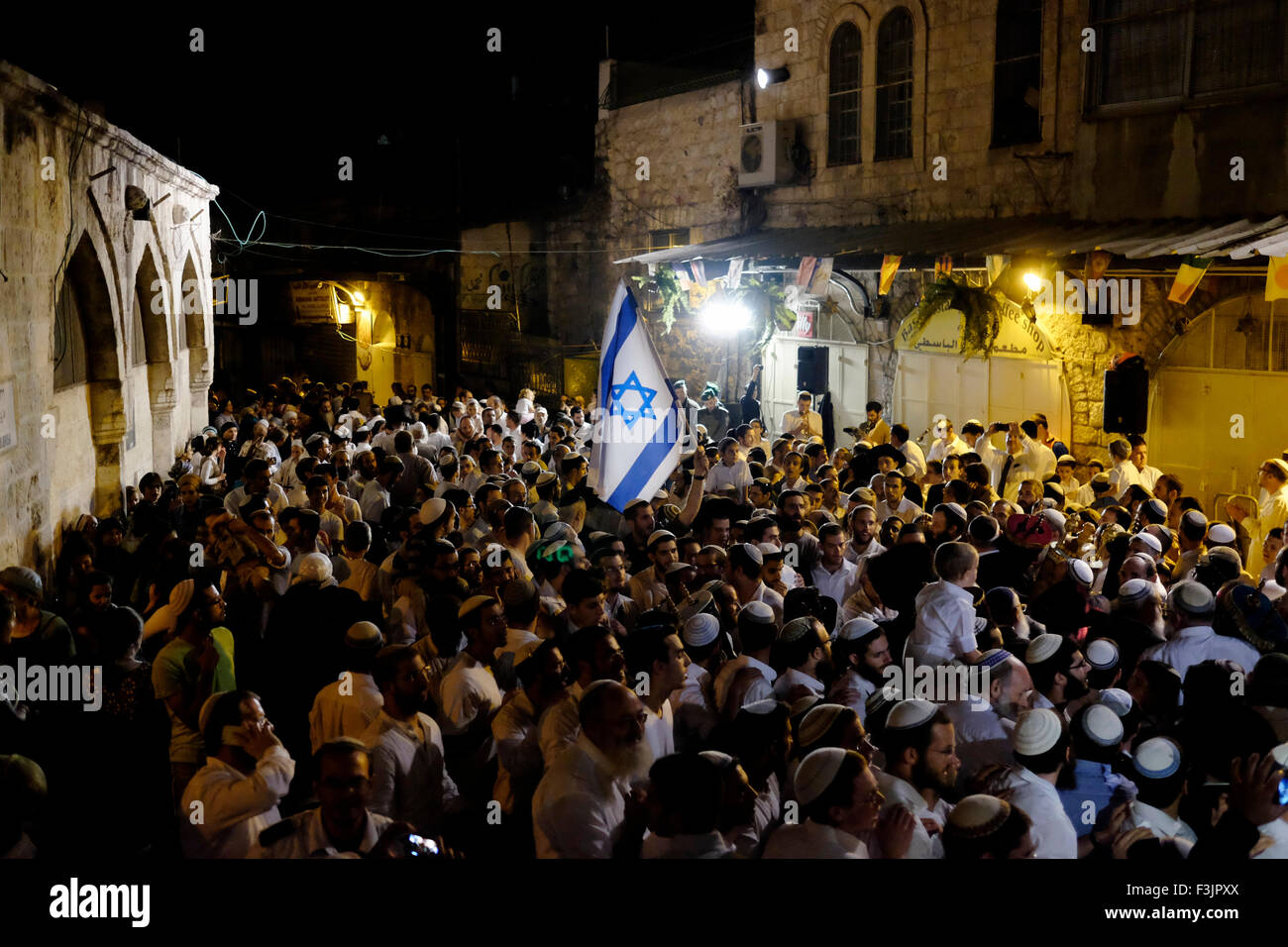 ISRAEL - JERUSALEM 05 OCTOBER: Hundreds of Israeli religious Jews marched to the site of the murders of Rabbi Nehemia Lavi and Aharon Banita Bennett who were murdered in a stabbing attack by a Palestinian last Saturday in Jerusalem's Old City on 05 October 2015. The marchers danced their way through the streets of the Muslim Quarter in the Old City then stopped at Hagai Street, the site of the murders, and there began singing louder and increasing their celebrations. Stock Photo
