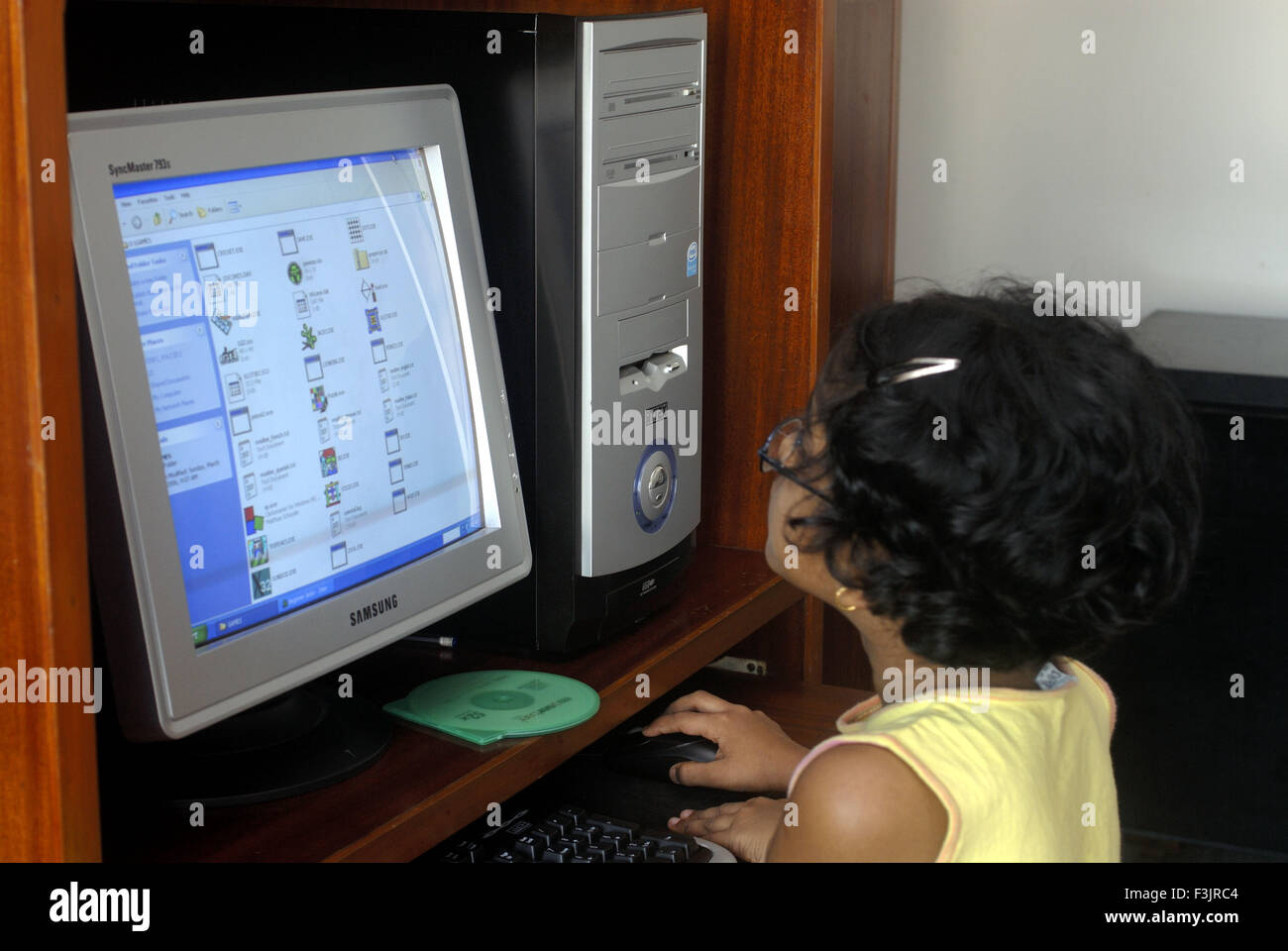 Seven years old girl wearing spectacles on computer Borivali Mumbai Maharashtra india asia MR# Stock Photo