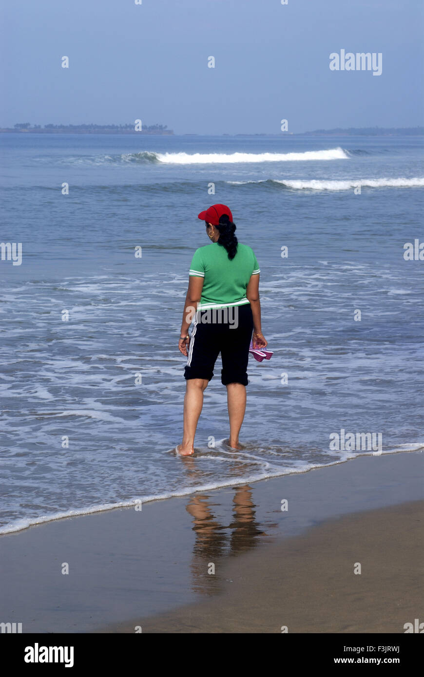 Woman tourist enjoying water Arabian sea Tarkarli beach near Malvan Konkan coast Sindhudurg maharashtra india   model released Stock Photo