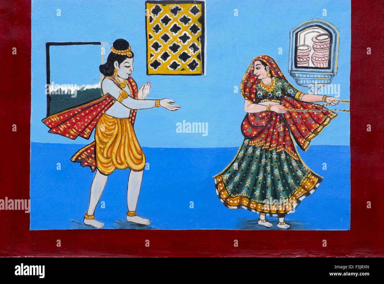 Young Lord Krishna teasing milkmaid for butter Colorful painting facade Udupi Sri Krishna Temple Karnataka india Stock Photo