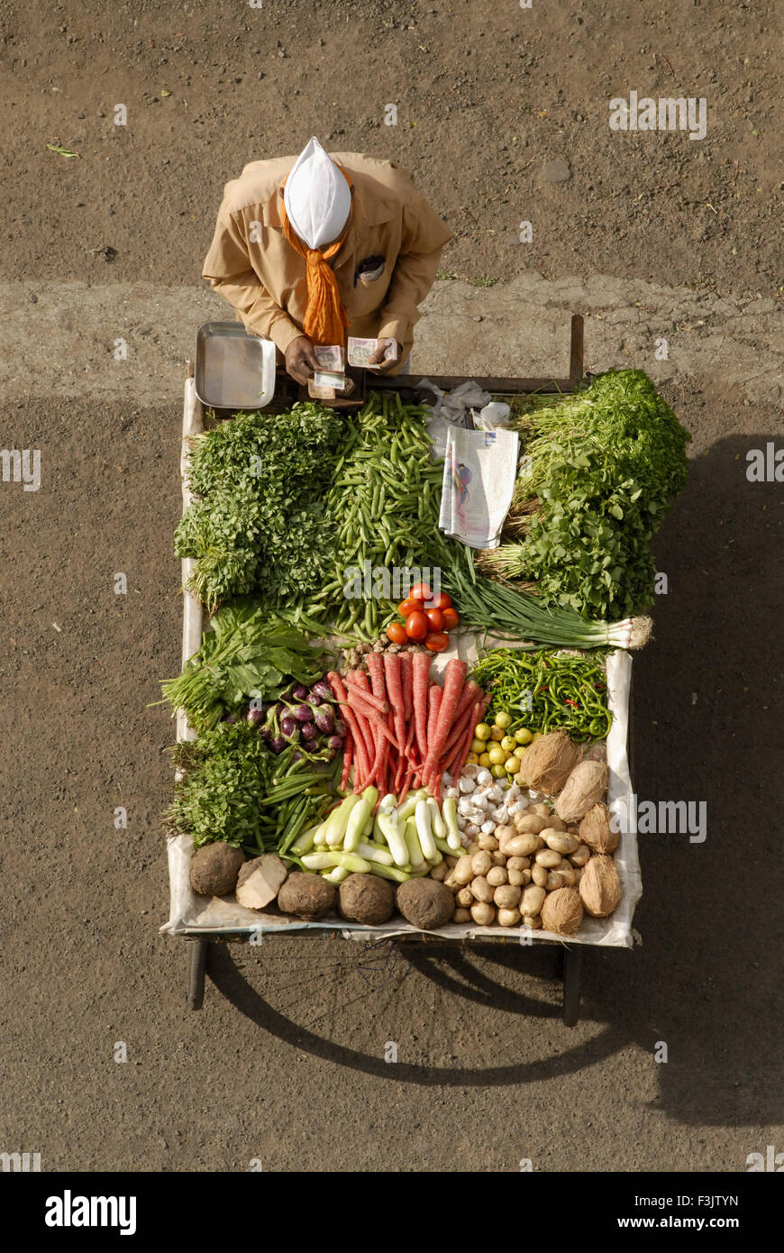 Aerial view of handcart with vegetable vendor wearing Gandhi cap at Pune Maharashtra India Stock Photo