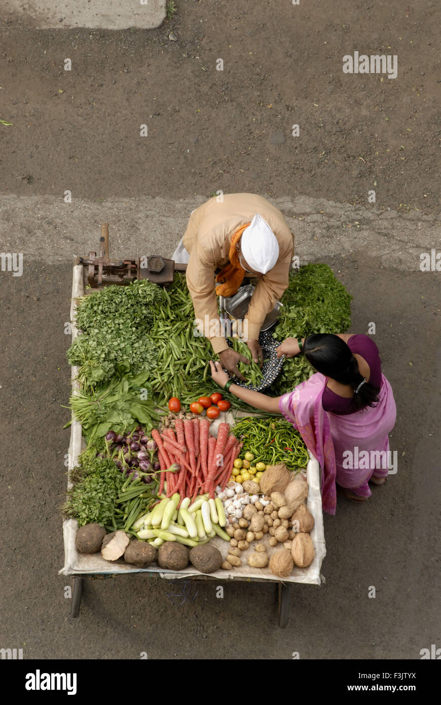 Aerial view of handcart with vegetable vendor wearing Gandhi cap at Pune Maharashtra India asia Stock Photo