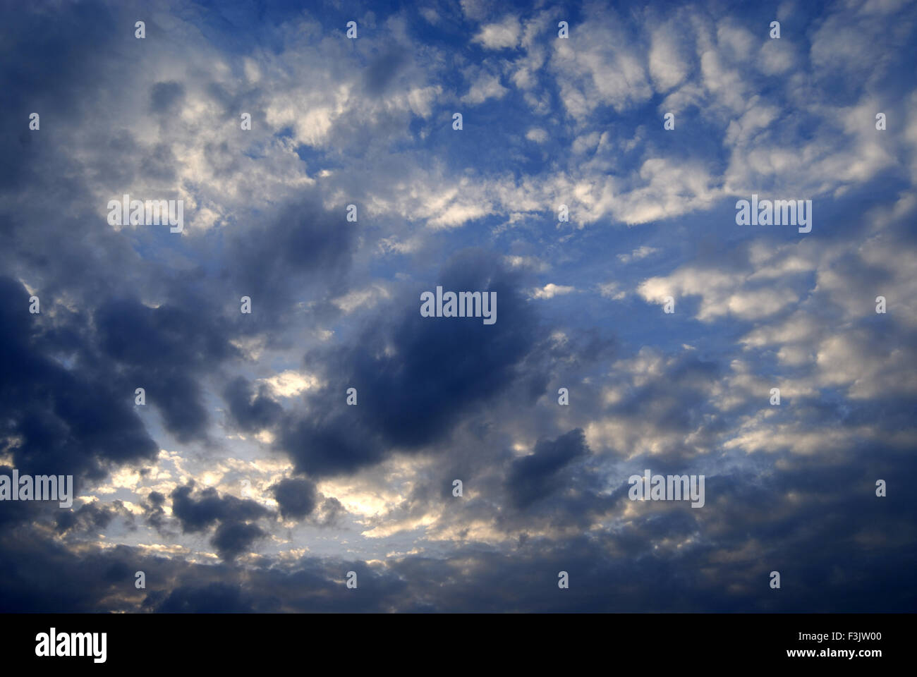 Dark Grey and white clouds with sparkling Sun at Pune ; Maharashtra ; India Stock Photo
