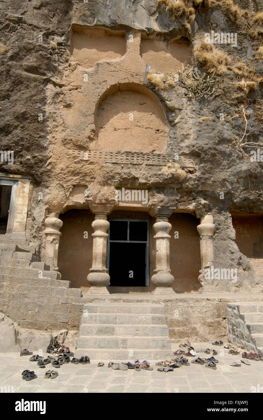 pillars at entrance of Buddhist caves on mountain at Lenyadri Stock ...