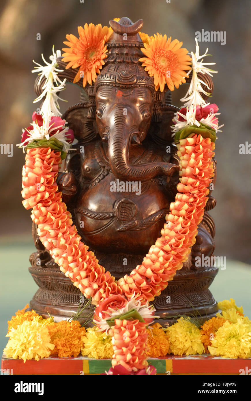 Wood Carved Idol Lord Ganesh Painted Copper Metal Garlanded Flowers Wood Carved Idol Lord Ganesh Painted Copper Metal Garlanded Flowers