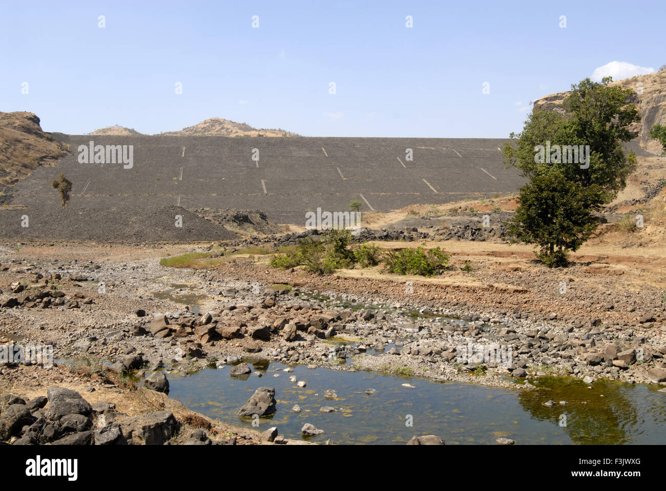 Earthen dam stone pitching constructed between rock mountains Chilhewadi village Otur Junnar Pune India Asia Stock Photo