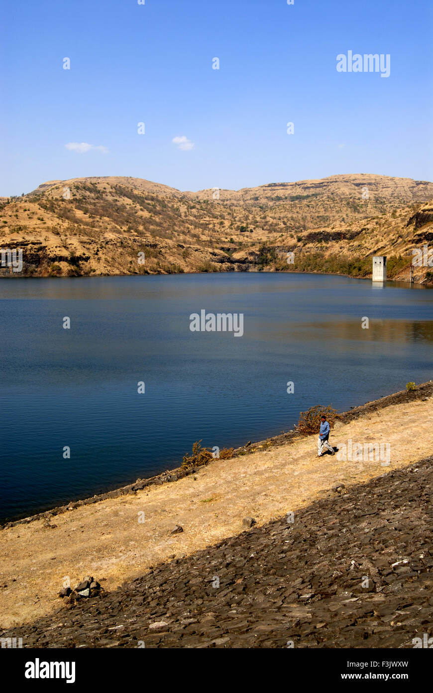 Earthen dam with stone pitching constructed between rock mountains at Chilhewadi village Otur Junnar Pune Maharashtra india asia Stock Photo
