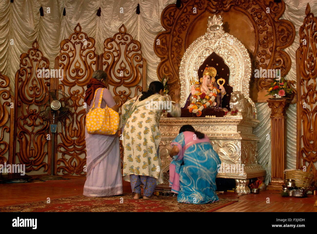 Women worshipers Richly decorated idol Lord Ganesh elephant headed God