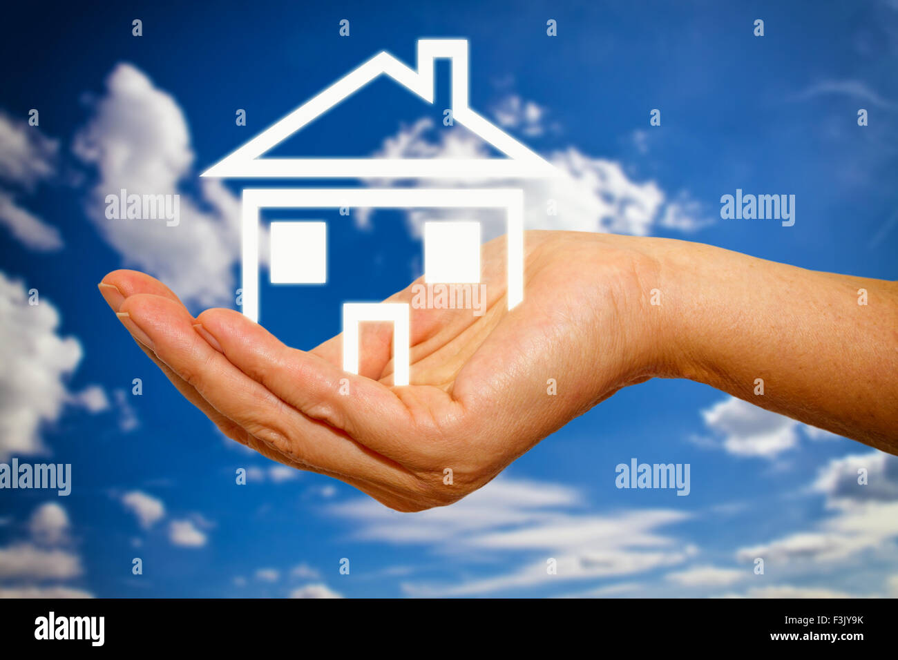 Shape of a house in a hand Stock Photo