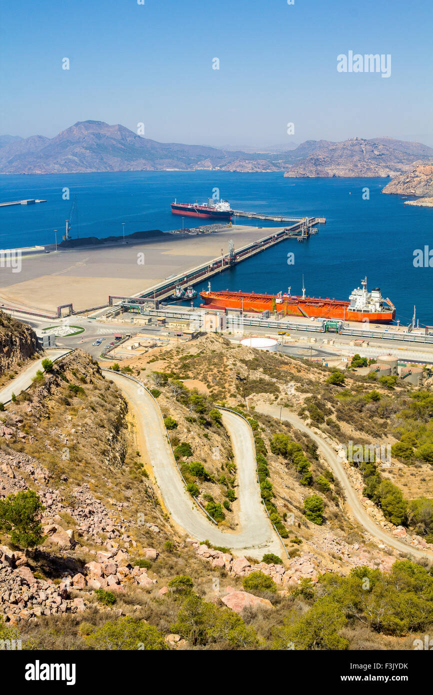 large tankers in a port next to a mountain Stock Photo