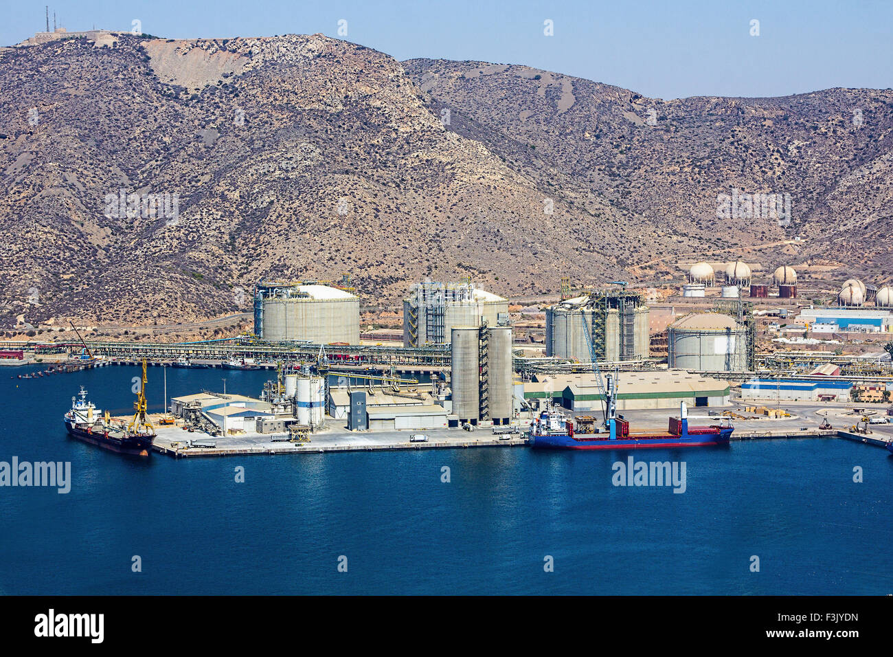 large boat load next to a refinery Stock Photo