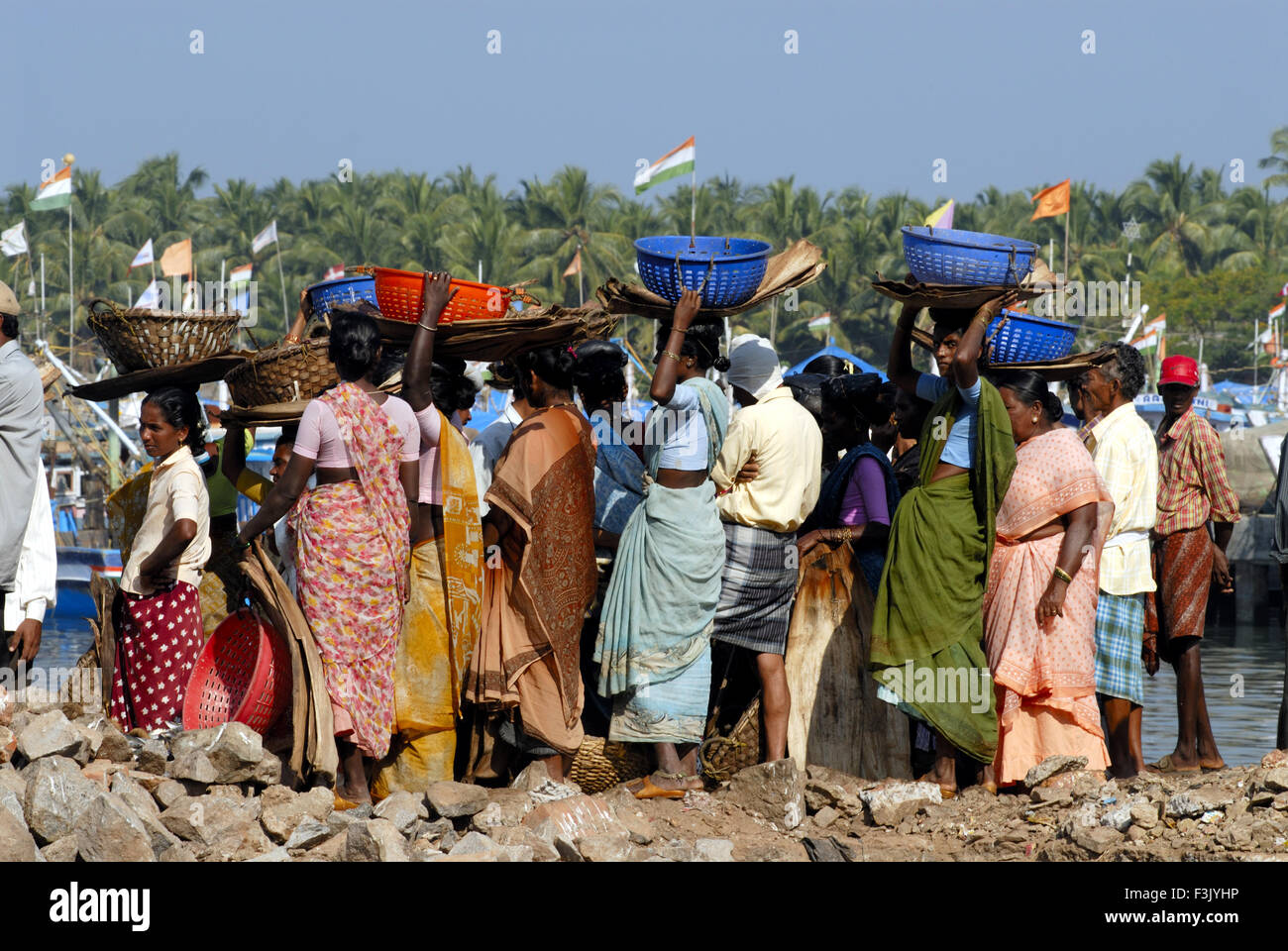 Fisherwomen and fishermen for buying fish at fishing yard ; Udupi Karnataka India asia Stock Photo