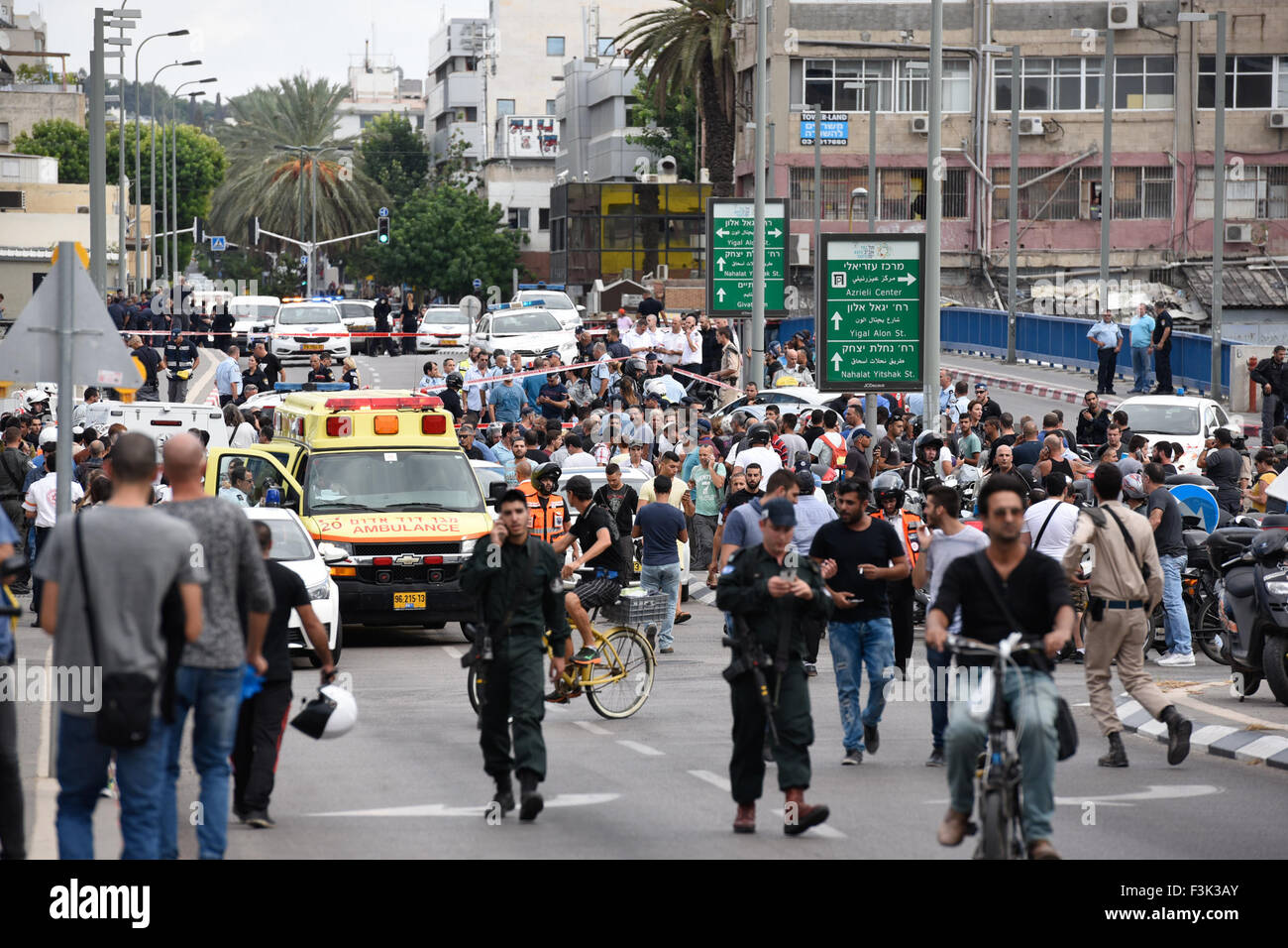 (151009) -- TEL AVIV, Oct. 9, 2015 (Xinhua) -- People watch the scene of an attack in Begin Street, central Tel Aviv, on Oct. 8, 2015. A Palestinian man was shot and killed on Thursday after stabbing two Israelis in Tel Aviv, as violence between Israelis and Palestinians spiraled, Israeli officials said. Police said the incident was a 'suspected terror attack,' and the assailant was 'neutralized.' A police spokesperson later added that the assailant stabbed a female soldier with a screwdriver in Begin Street, near the Defense Ministry and IDF headquarters complex. He then stabbed another perso Stock Photo