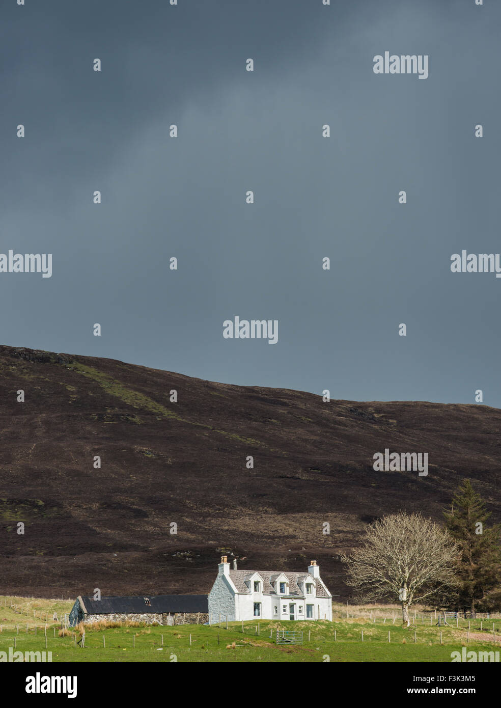 Cottage Isle of Skye in Scotland with dark sky. Stock Photo