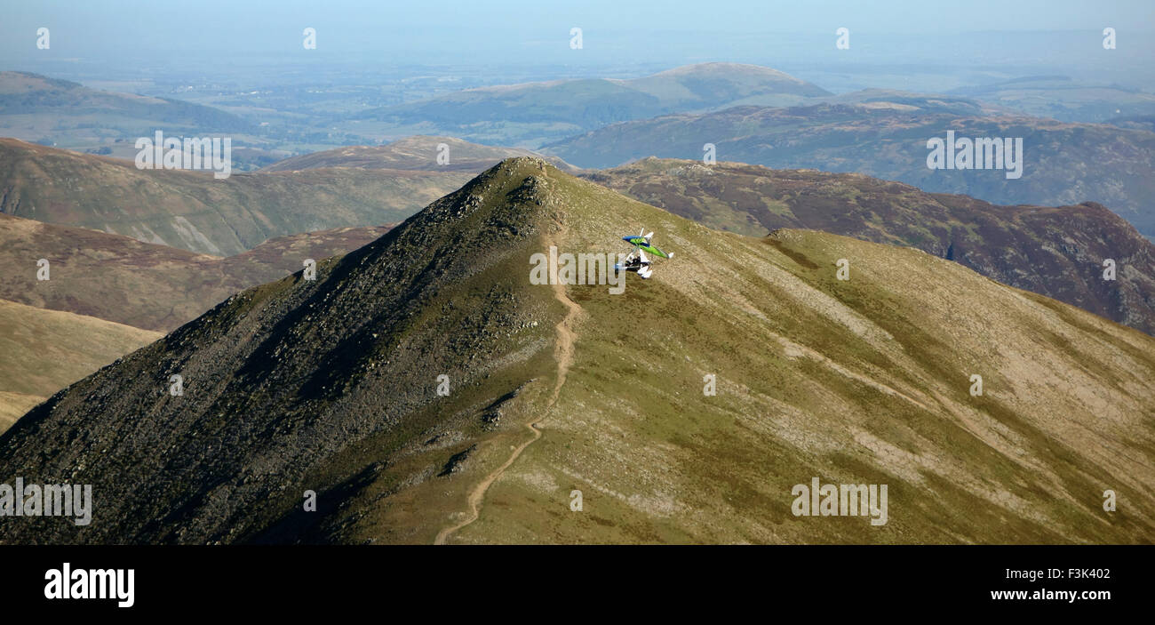 A micro lite flies below Helvellyn and above Catseyecam on a clear day Stock Photo