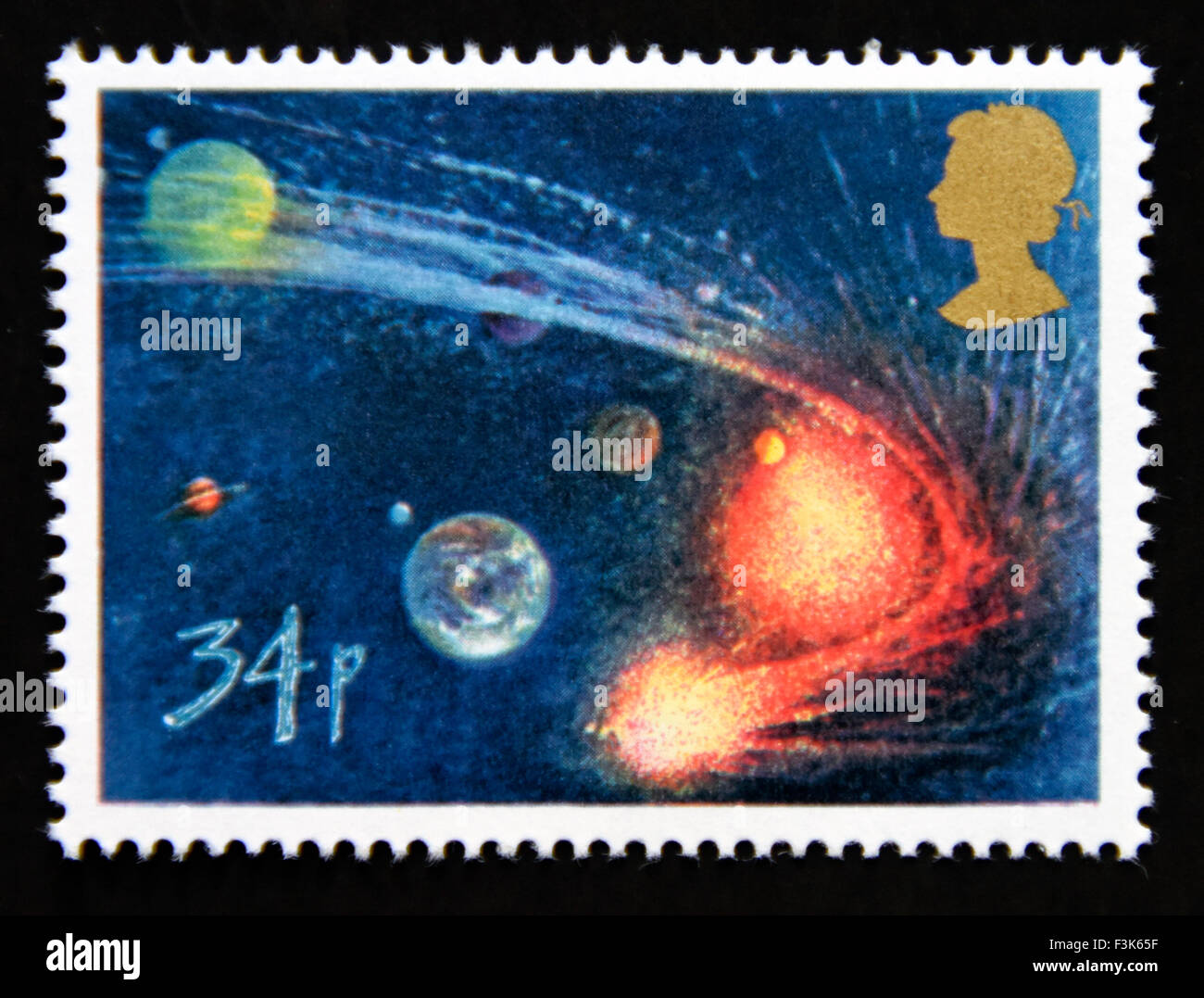 Postage stamp. Great Britain. Queen Elizabeth II. 1986. Appearance of Halley's Comet. Comet orbitting Sun and Planets. 34p. Stock Photo