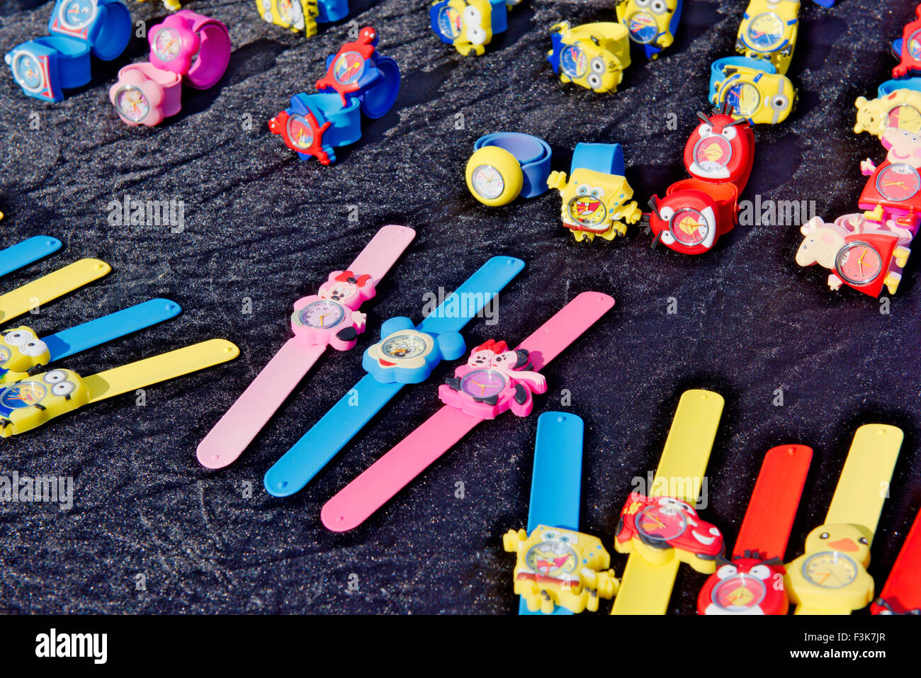 Children's watches with cartoon characters on display at outdoor market stall, UK Stock Photo