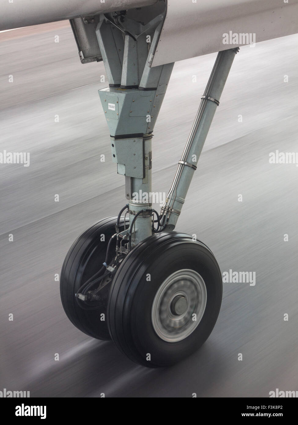 The blurred wheel of an aircraft at takeoff on the airport runway Stock