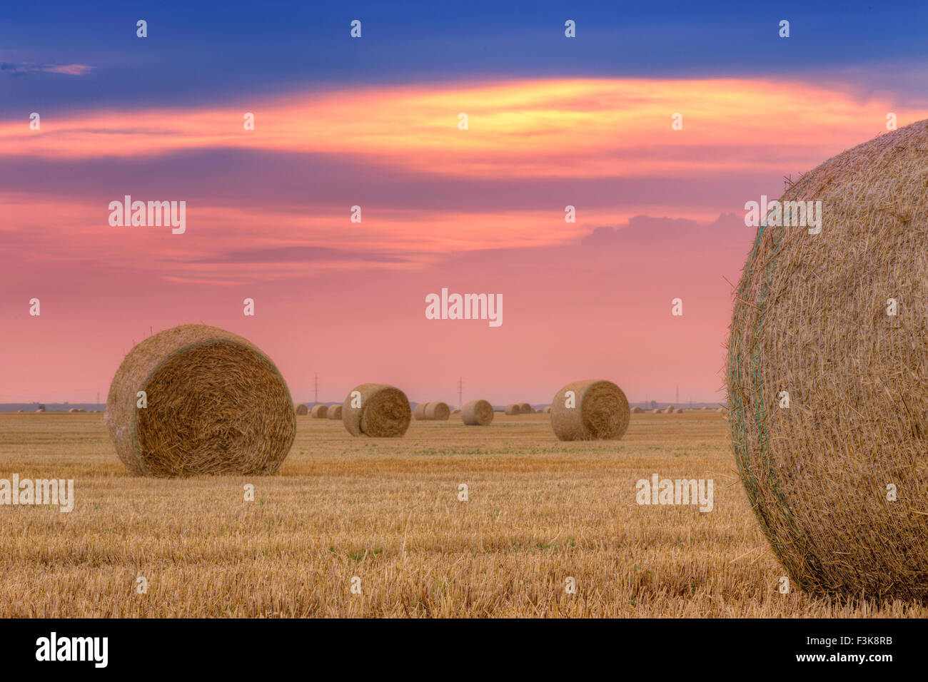 Straw bales with dramatic sky in Hungary Stock Photo