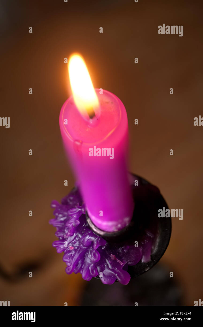 Softly glowing pink candle Stock Photo