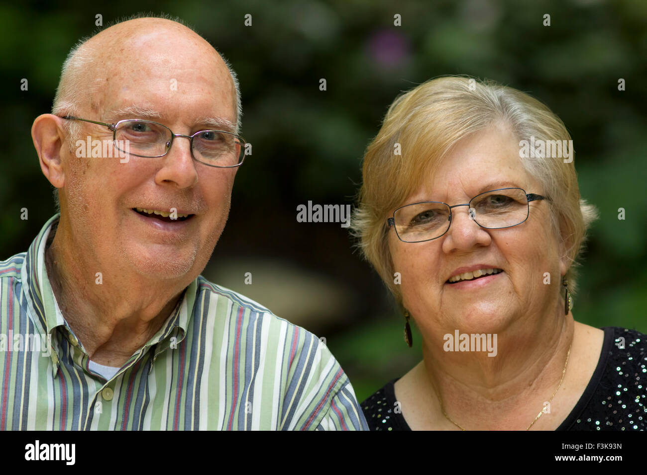 A happy looking senior couple smiling for the camera. Stock Photo
