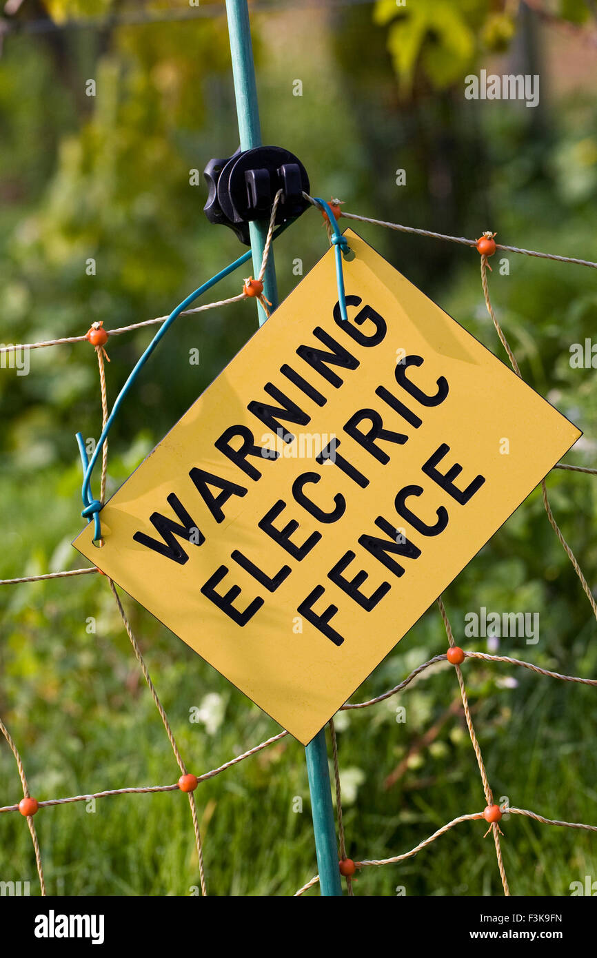 Electric fence warning sign. Stock Photo