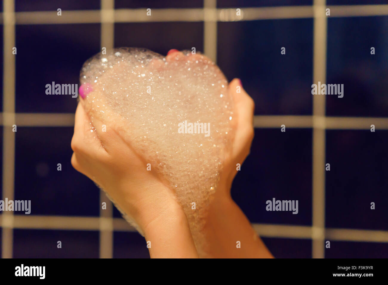 Woman's hands holding bubble bath foam heart Stock Photo Alamy