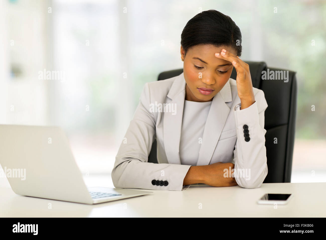 stressed African businesswoman sitting in office Stock Photo - Alamy