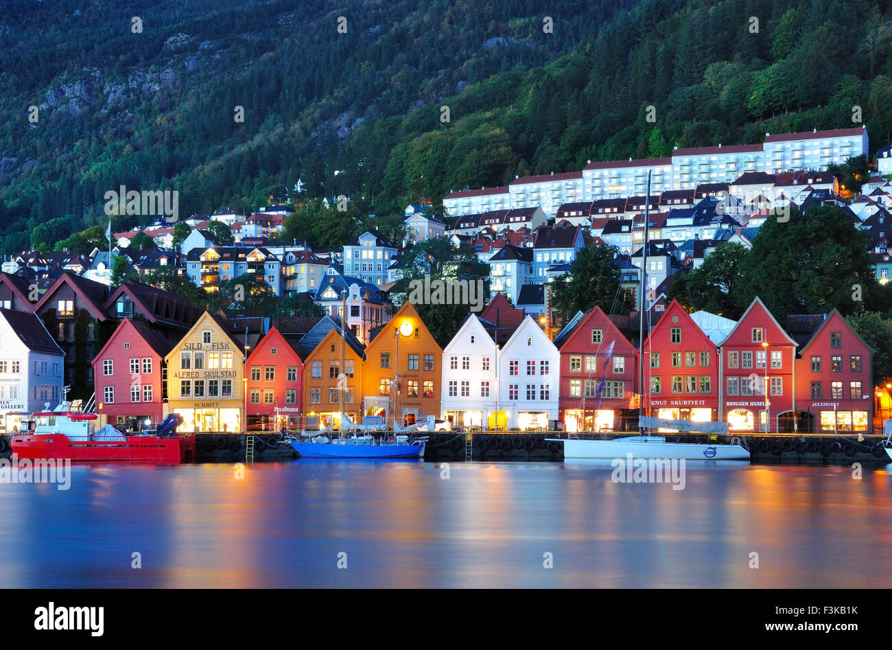 Colorful wooden house of Bryggen Hanseatic Wharf at night, a UNESCO World Heritage site with shops, hotels, and restaurants. Stock Photo