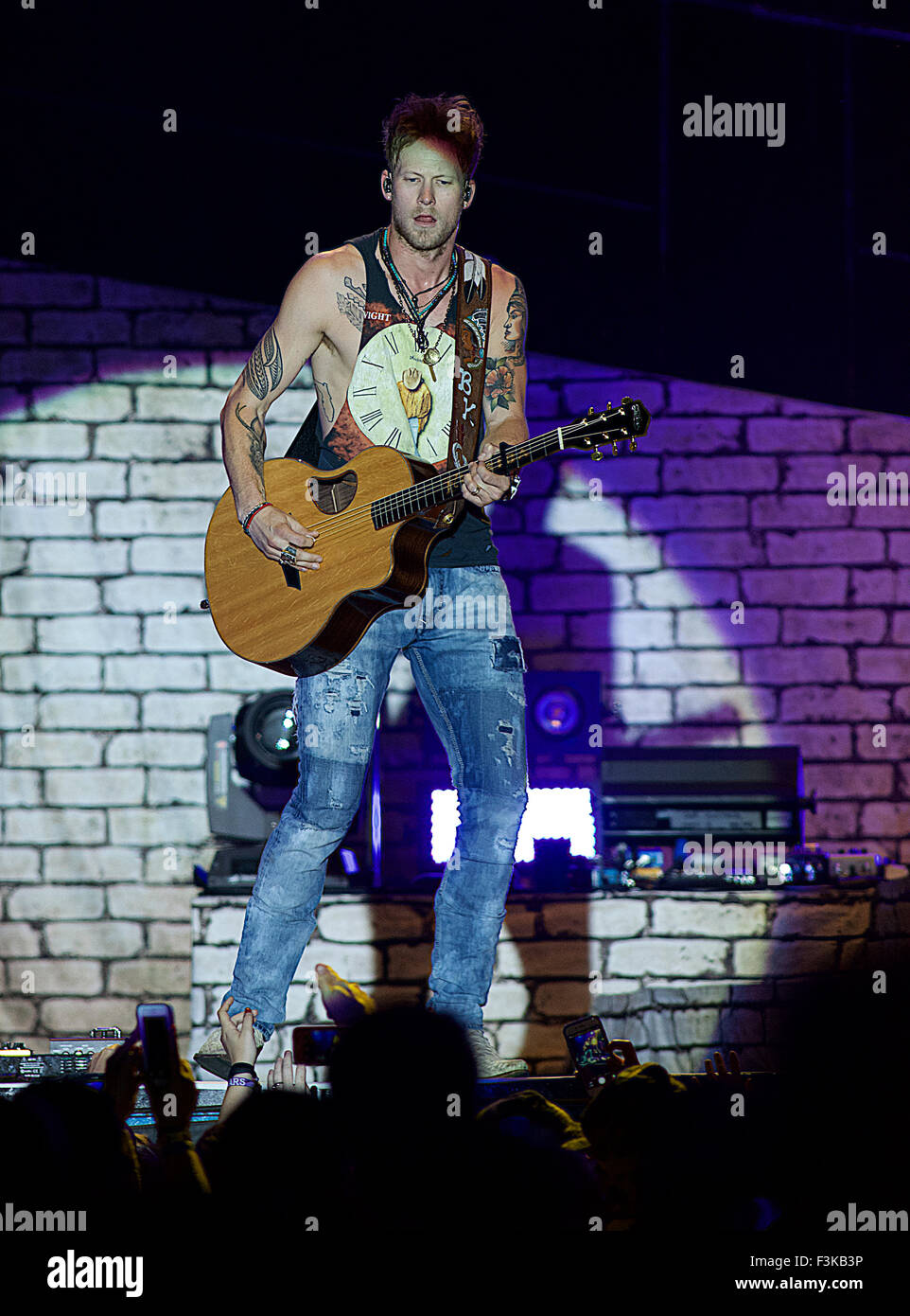 Manhattan, Kansas  6-26-2015 Brian Kelley  of Florida Georgia Line at the Kicker Country concert in Manhattan, Kansas. Florida Georgia Line is an American bro-country duo comprising Brian Kelley (from Ormond Beach, Florida) and Tyler Hubbard (from Monroe, Georgia). Florida Georgia Line was formed in 2010 in Nashville, Tennessee. In December 2011, they signed a publishing/production/management deal with Craig Wiseman (Big Loud Shirt Publishing), Kevin 'Chief' Zaruk (Chief Music Management), and Joey Moi's (Mountain View Records) partnership, Big Loud Mountain.[2] Their second EP, It'z Just What Stock Photo