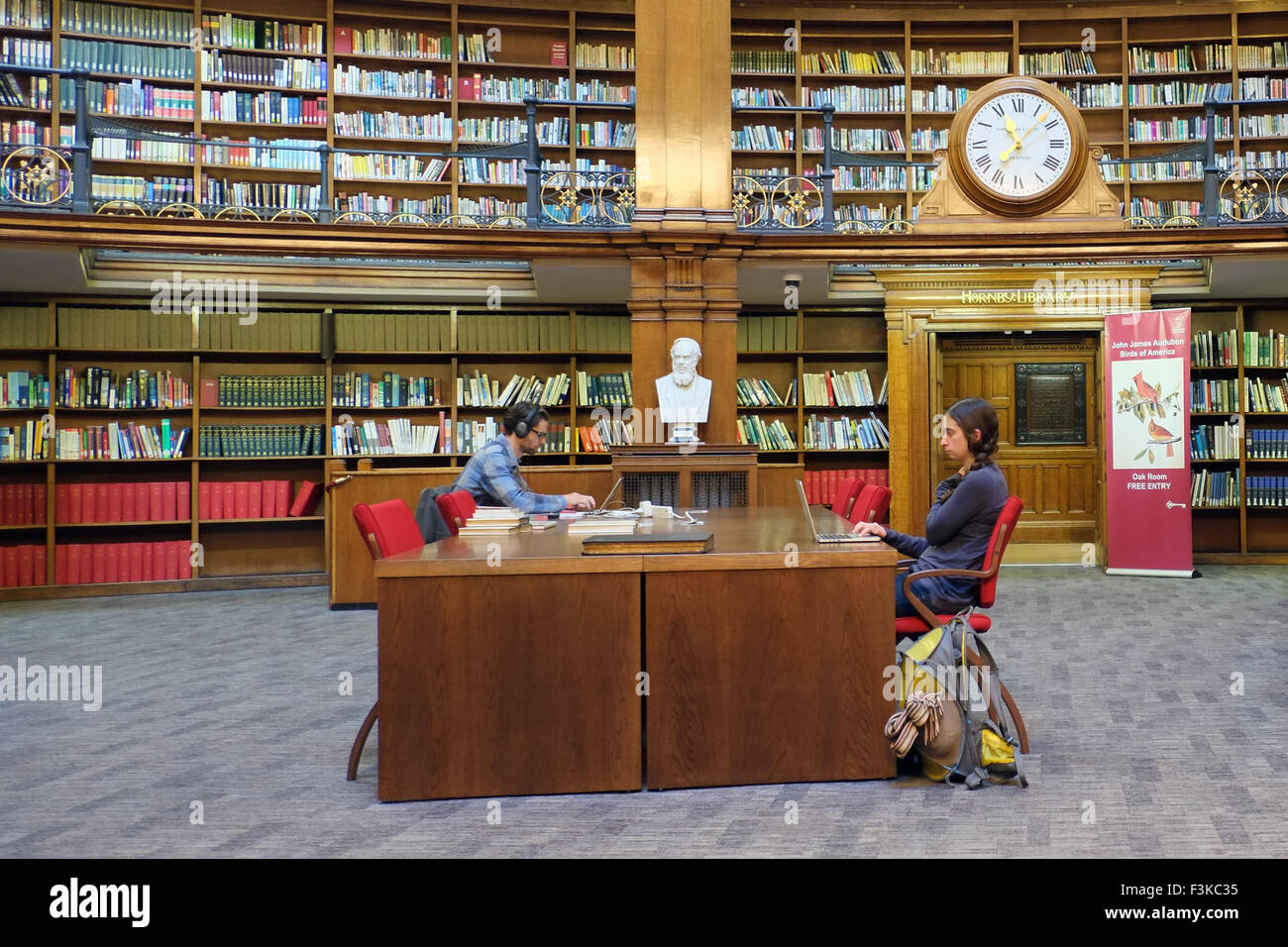 A picture of the inside of Liverpool's famous study Picton library with students, stacked shelves, clock & ornate fittings, Liverpool, Merseyside, UK Stock Photo
