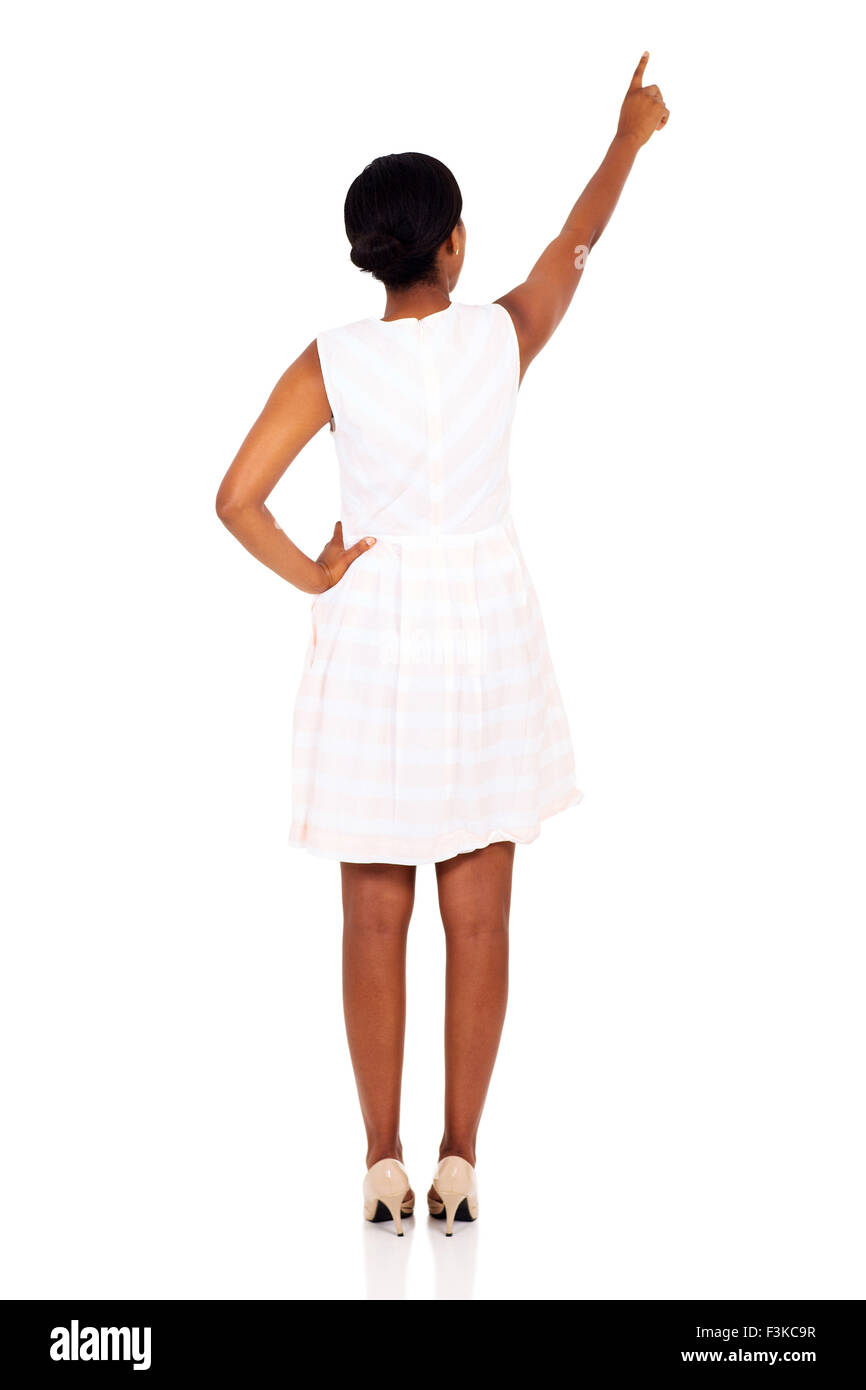 rear view of African woman pointing empty copy space on white ...