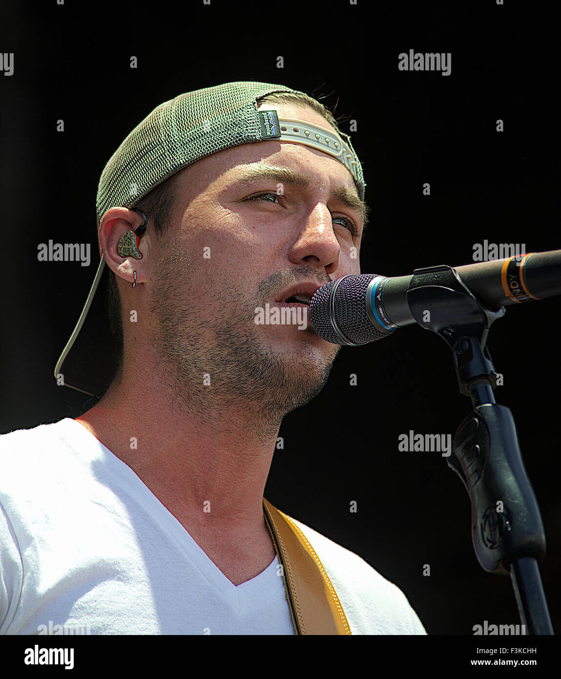 Manhattan, Kansas  6-28-2015 Eric Gunderson of Love and Theft performs at the Kicker Country Stampede in Manhattan, Kansas. Love and Theft is an American country music duo composed of Stephen Barker Liles and Eric Gunderson, both of whom sing lead vocals and play guitar. They originally formed as a trio in 2006 in Nashville, Tennessee, along with Brian Bandas (who also sang lead and played guitar). Signed to Lyric Street Records subsidiary Carolwood Records in 2009, Love and Theft made their chart debut in early 2009 with the single 'Runaway,' which reached the Top 10 on Billboard Hot Country Stock Photo