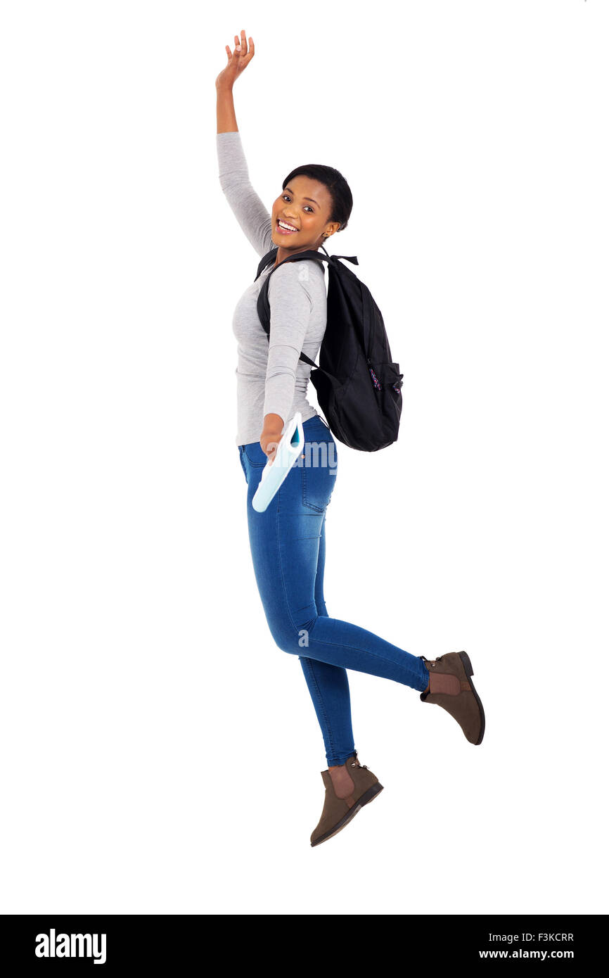 cheerful young female African college student jumping on white background Stock Photo