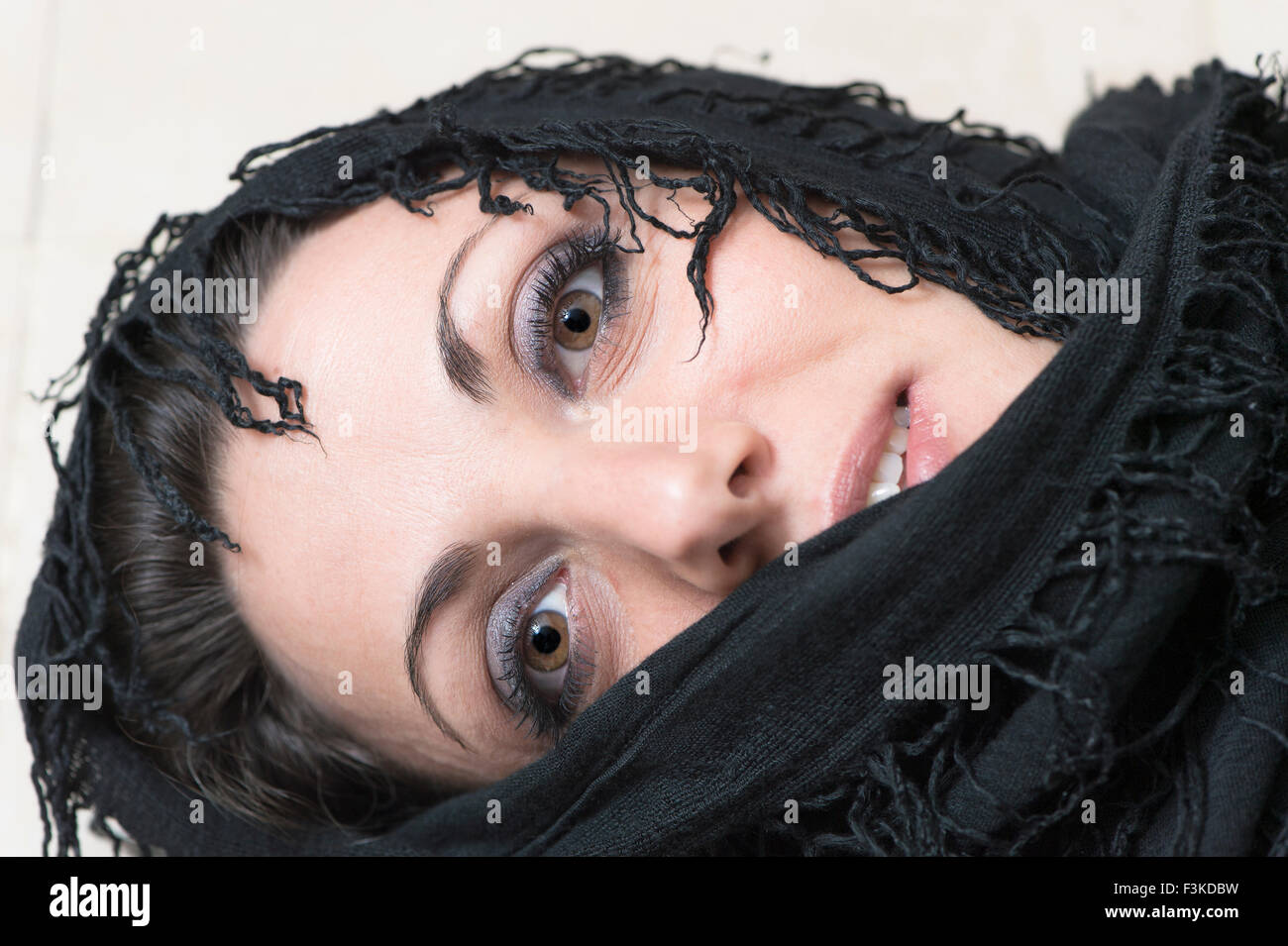 woman with face wrapped in a black shawl Stock Photo - Alamy
