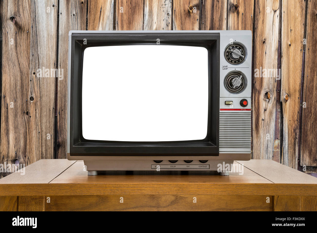 Vintage portable television with cut out screen and rustic cabin wall