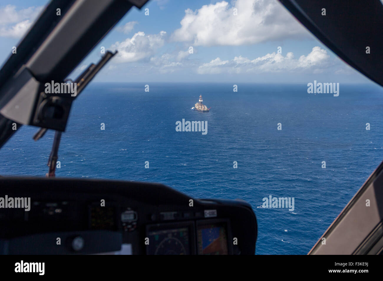 Helicopter approaching an oil drill ship in the Indian Ocean Stock Photo