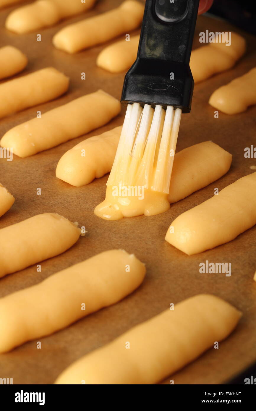 Brush pastry with egg glaze. Making Eclair Stock Photo Alamy