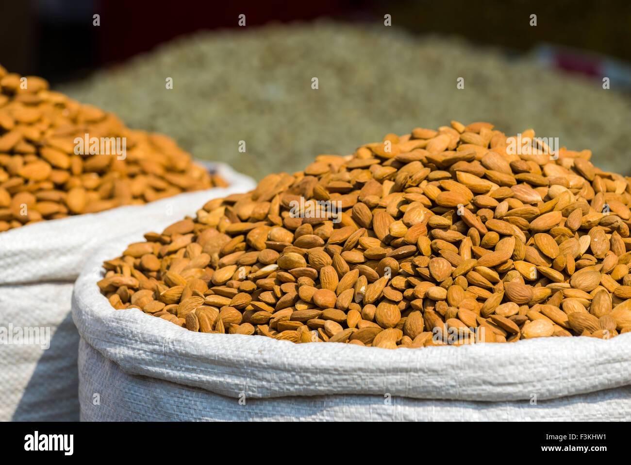 Almonds are displayed in a sack in the Old Delhi spice market Stock Photo