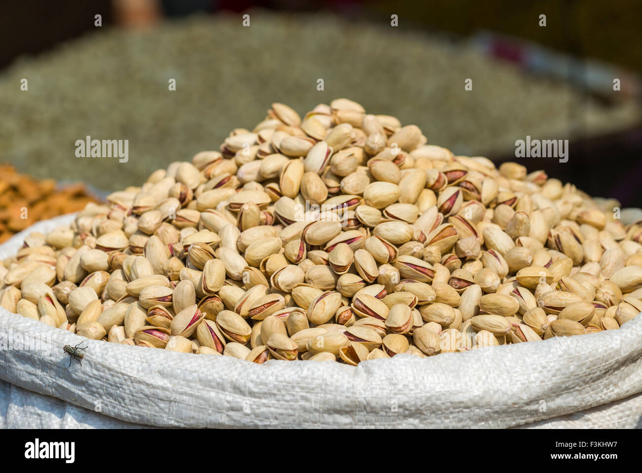 Pistachios are displayed in a sack in the Old Delhi spice market Stock Photo