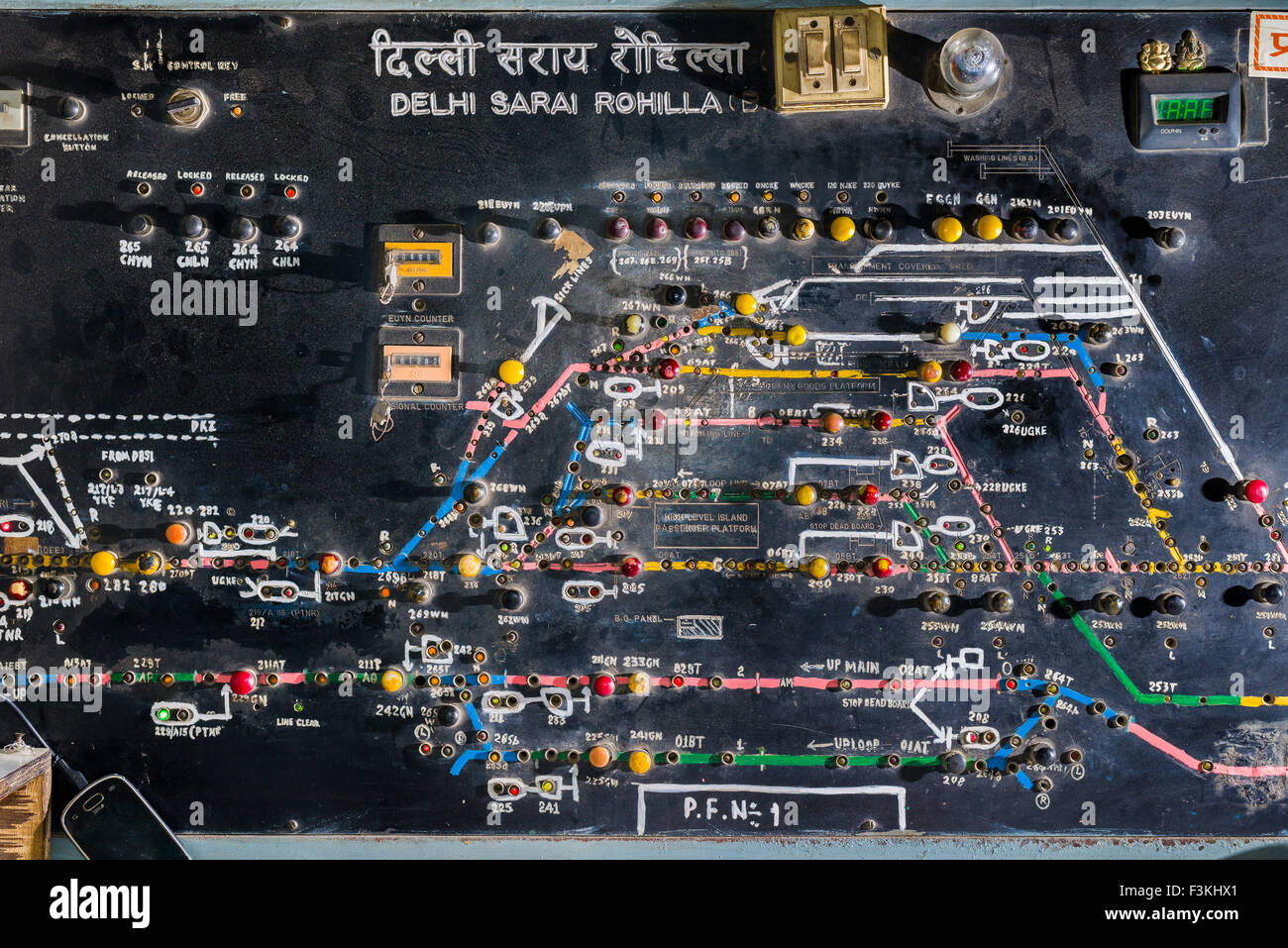 The board for coordinating the trains arriving and leaving the Railway Station Delhi Sarai Rohilla by hand Stock Photo