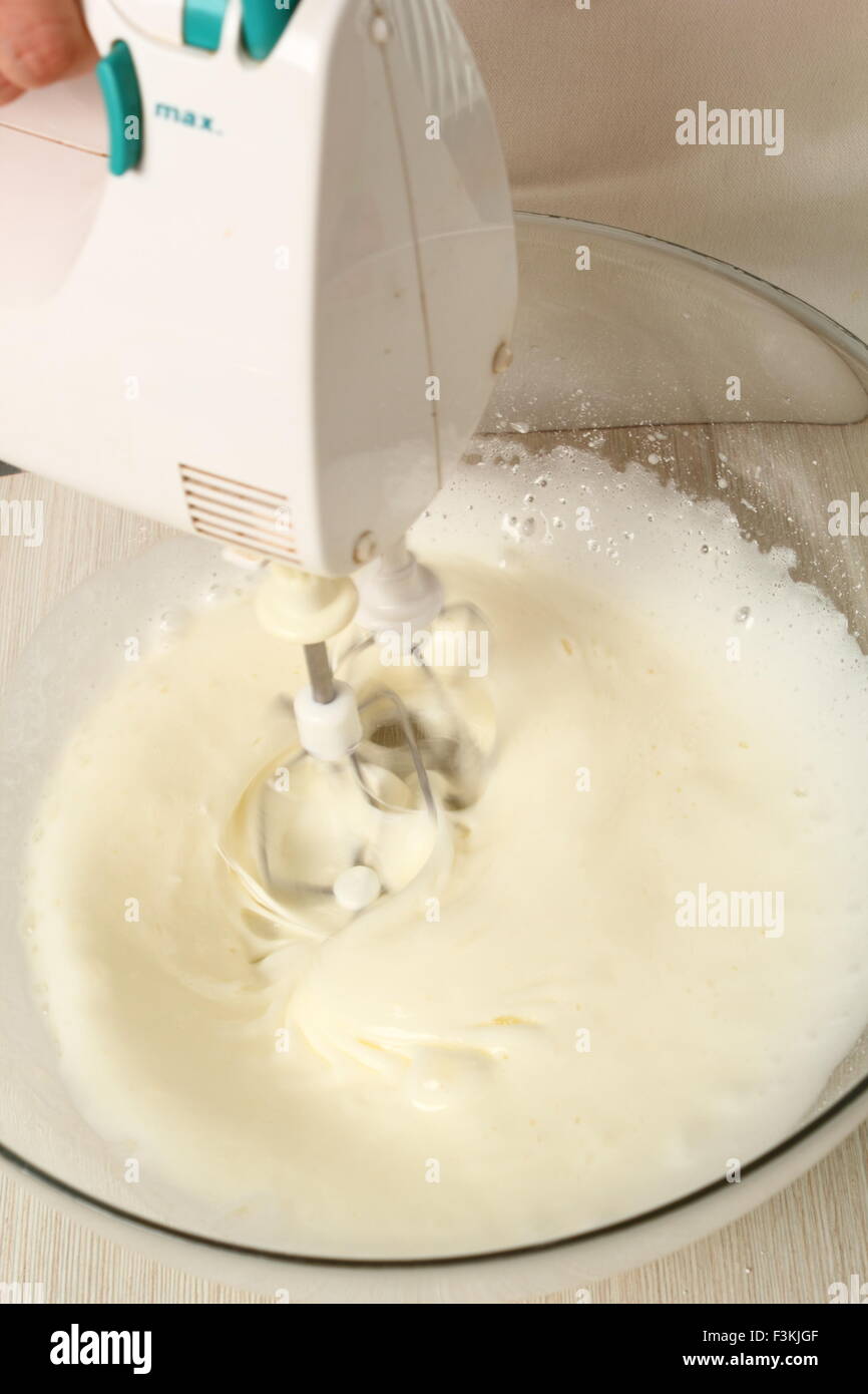 Whisking egg whites and granulated sugar. Making Chocolate Hazelnut